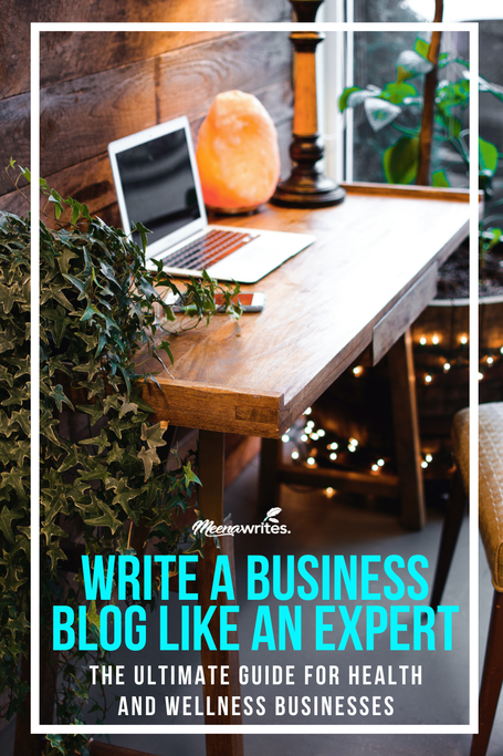 laptop on a desk with a salt lamp next to it