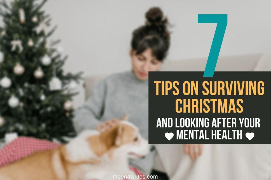 WOMAN PATTING DOG SITTING NEAR A CHRISTMAS TREE